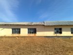 classrooms look OK from a distance BUT...Termite damage causes the roof to sag. Eventually it will fall in.