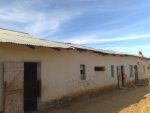 classrooms look OK from a distance BUT eneven roof edge is a clue to trouble